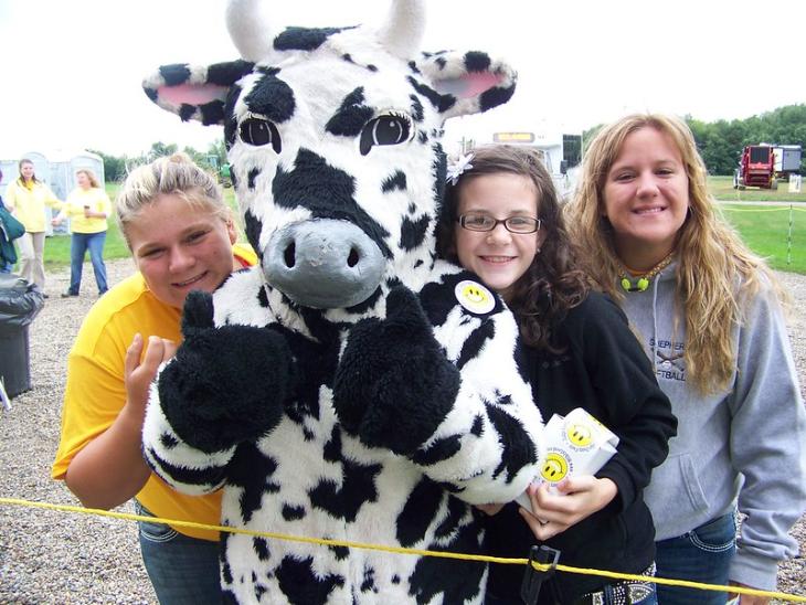 Picture of youth with cow mascot