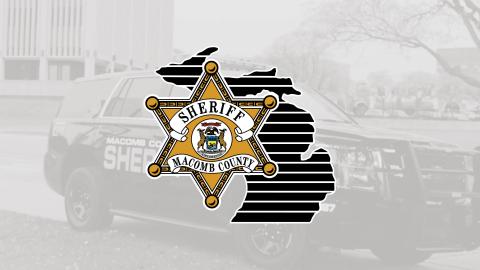 sheriff logo in front of a sheriff vehicle