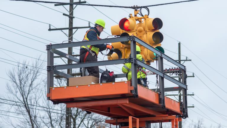 Macomb County Department of Roads personnel install traffic signal heating technology