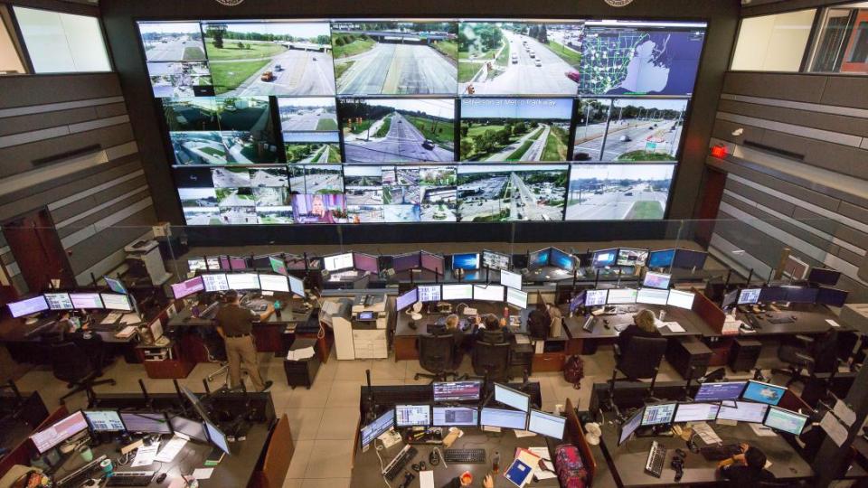 dispatch center with a wall full of tvs to monitor the roads