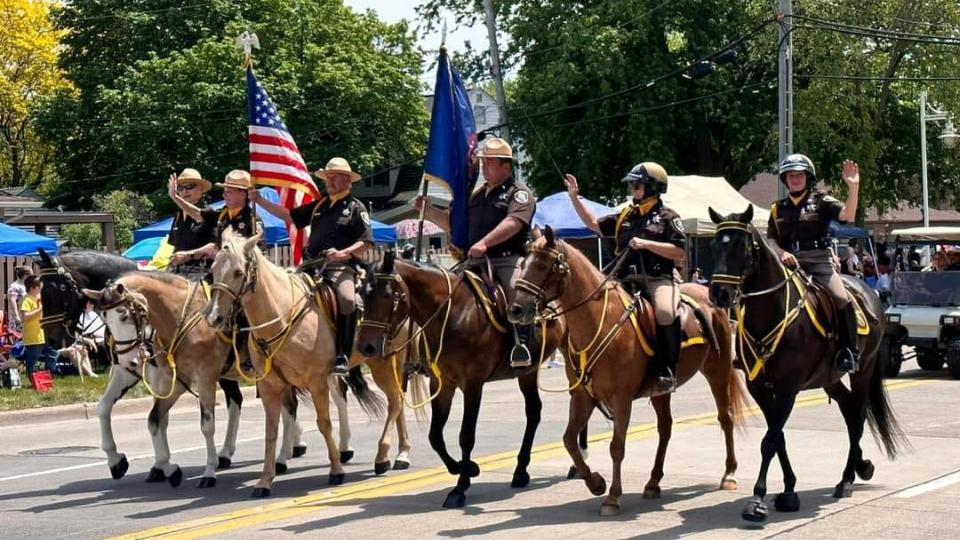 MAcomb County Sheriffs on horses in a parade