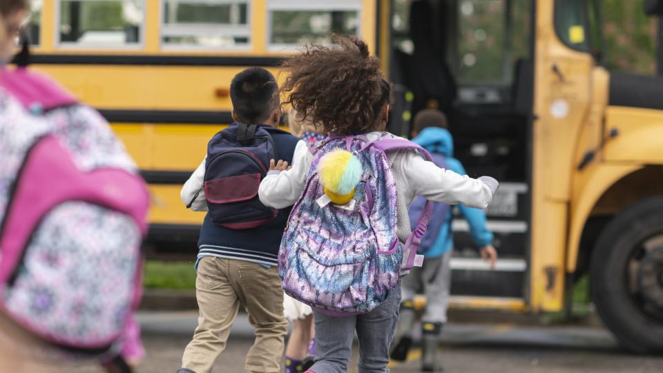 Image of school bus and children