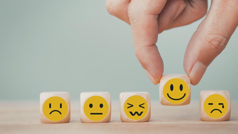 Emoji faces of various expressions on dice