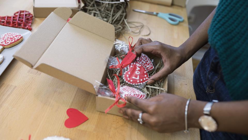woman packs valentine's day gift box
