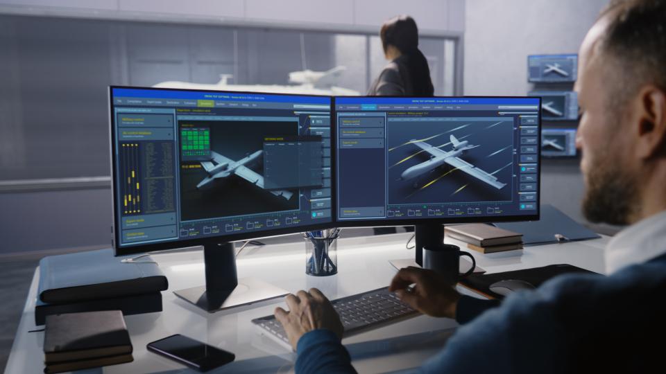 engineer designs a plane using a CAD program