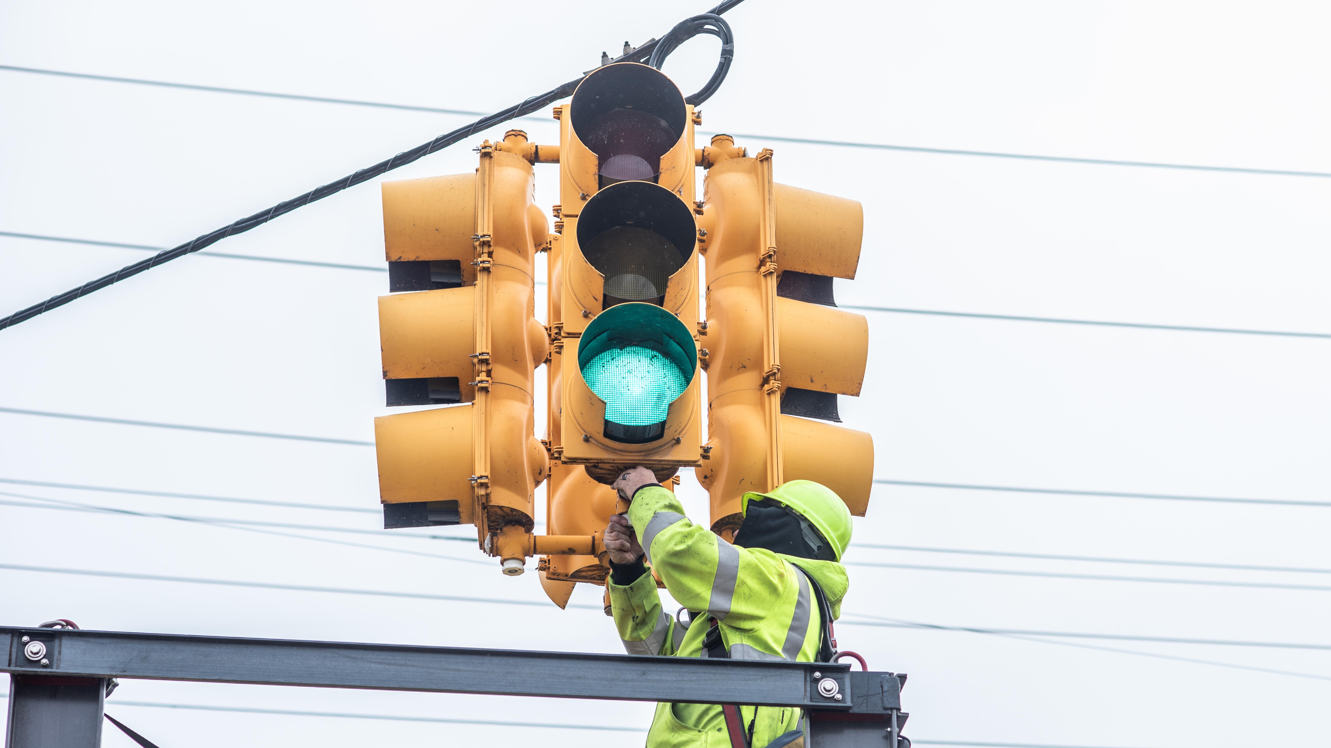 Macomb County Department of Roads personnel install traffic signal heating technology