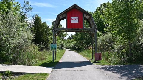 red barn feature over a paved trail