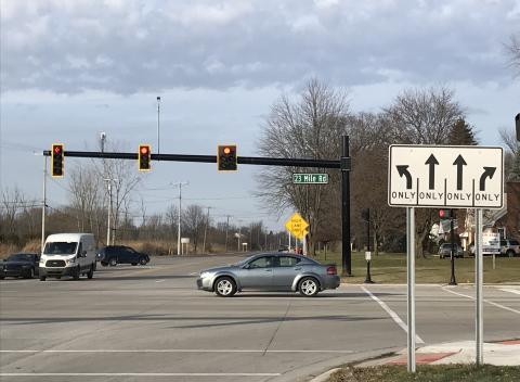 Vehicles traveling through 23 Mile Road intersection.