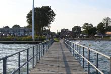 a pier stretches into a waterway
