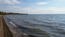 Lake St. Clair beach freshly groomed with light waves rolling onshore.